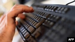 Russia -- An employee types on a computer keyboard at the headquarters of Internet security giant Kaspersky in Moscow, October 17, 2016