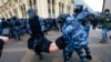 RUSSIA – Police officers detain a man during a protest against the jailing of opposition leader Alexei Navalny in Moscow, Russia, Sunday, Jan. 31, 2021