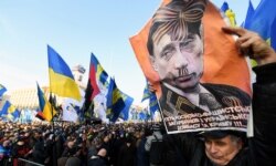 Плакат із зображенням президента Росії Володимира Путіна під час акції «Червоні лінії для Зе». Київ, 8 грудня 2019 року