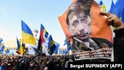 Плакат із зображенням президента Росії Володимира Путіна під час акції «Червоні лінії для Зе». Київ, 8 грудня 2019 року 